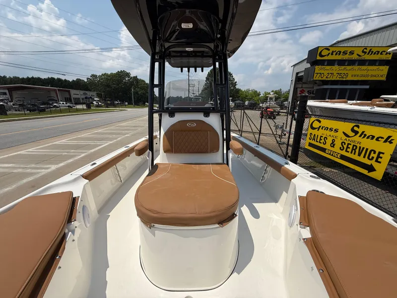 Slide: The Image of 2025 Key West 250BR boat with tan cushioned seating on deck. - 18