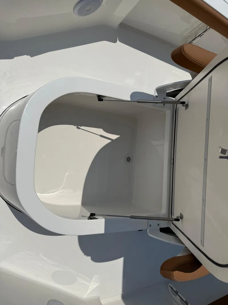 Slide: The Image of 2025 Key West 250BR boat with brown cushioned seating in the bow area. - 19