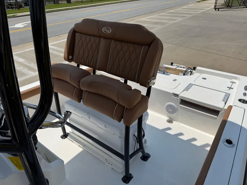 Slide: The Image of 2025 Key West 250BR boat with tan seating, parked near a sales and service shop. - 22