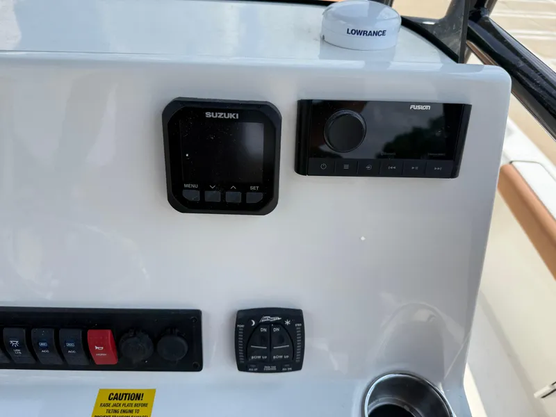 Slide: The Image of Key West 250BR 2025 boat raw water outlet with chrome valve and brown seating. - 31