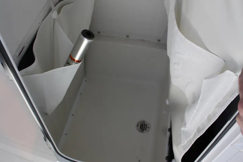 Slide: The Image of 2025 Key West 250BR boat interior with tan trim and rod holders. - 33