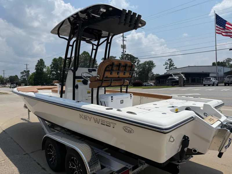Slide: The Image of 2025 Key West 250BR boat on trailer, parked outdoors under cloudy sky. - 4