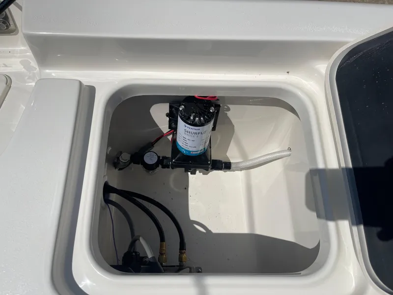 Slide: The Image of 2025 Key West 250BR boat compartment with installed pump system. - 40