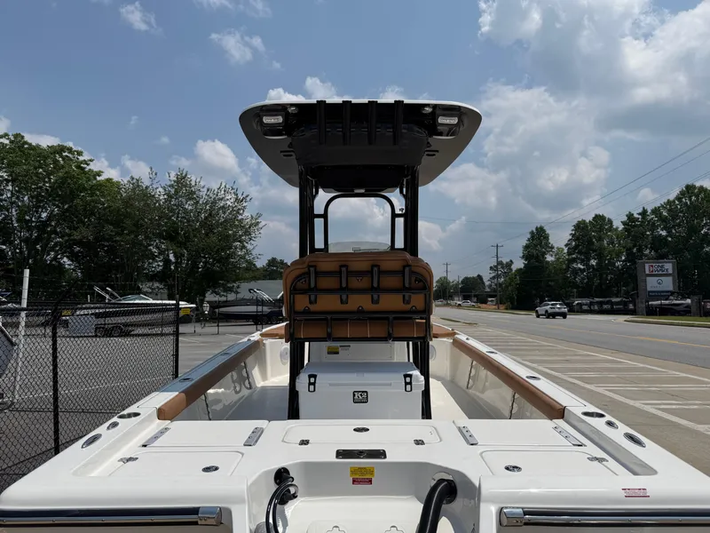 Slide: The Image of 2025 Key West 250BR boat on trailer, parked outside dealership under cloudy sky. - 5