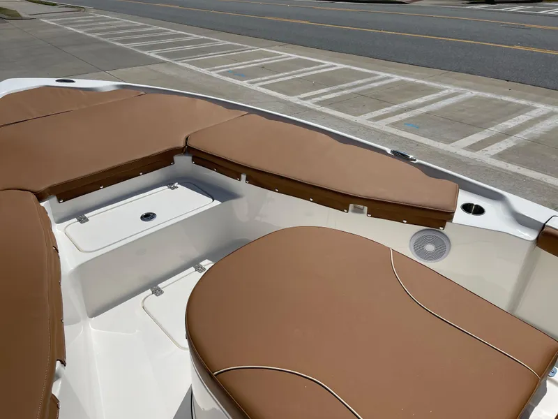 Slide: The Image of 2025 Key West 250BR boat, center console, parked outdoors under a cloudy sky. - 9