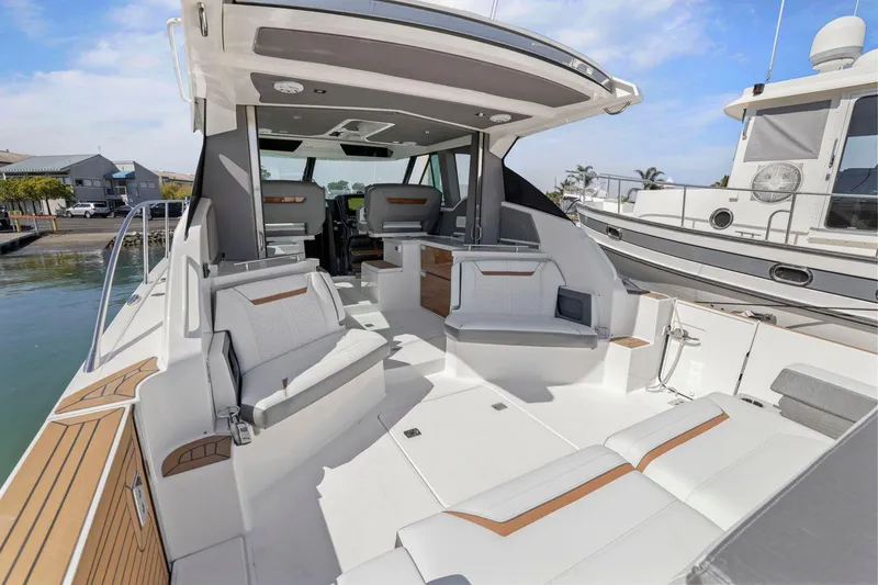 Slide: The Image of 2022 Tiara Yachts 43 LE luxury boat interior with spacious seating and modern design. - 14