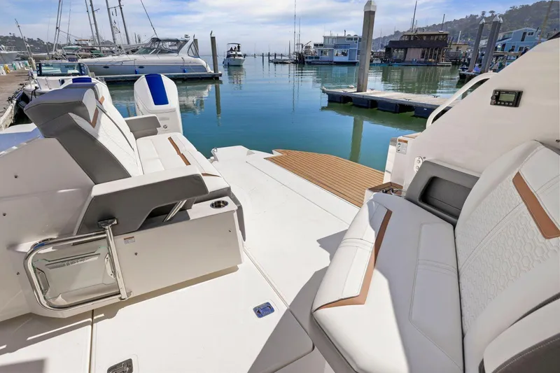 Slide: The Image of 2022 Tiara Yachts 43 LE interior, featuring luxurious seating at a marina. - 17