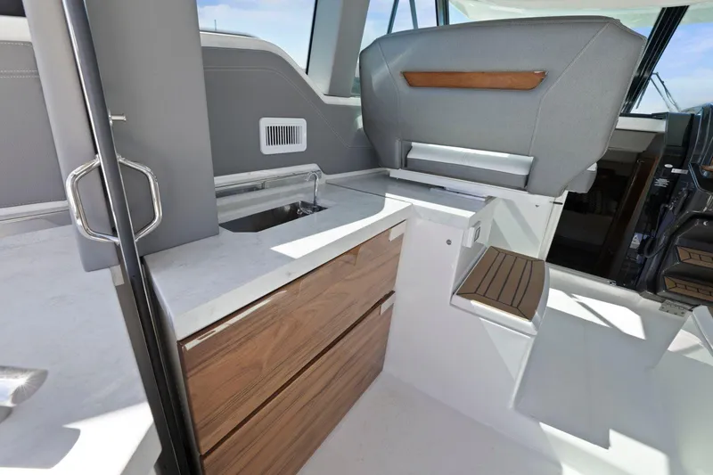 Slide: The Image of Interior of 2022 Tiara Yachts 43 LE, featuring modern cabinetry and seating. - 22