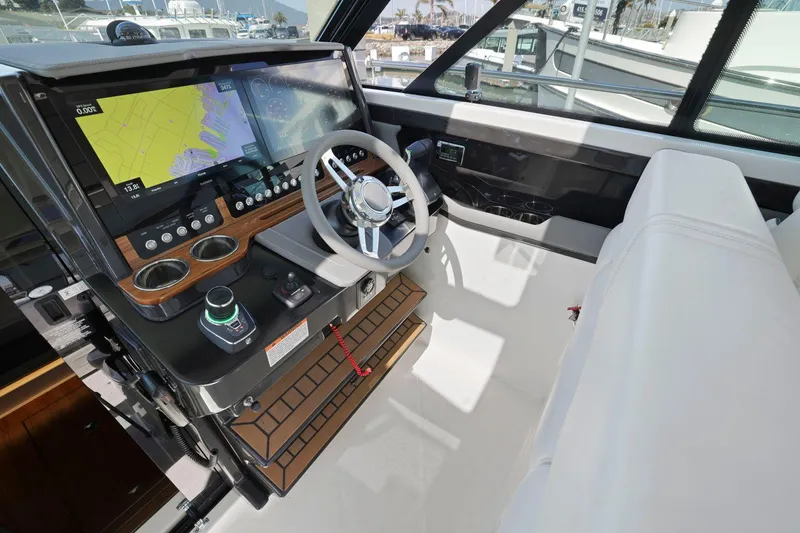 Slide: The Image of Helm of 2022 Tiara Yachts 43 LE with modern navigation equipment and steering wheel. - 24