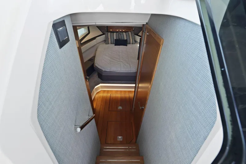 Slide: The Image of Interior cabin of 2022 Tiara Yachts 43 LE with wooden flooring and cozy bed. - 27
