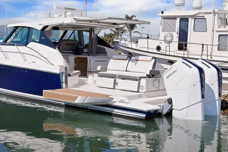 Slide: The Image of 2022 Tiara Yachts 43 LE docked, showcasing sleek design and spacious deck area. - 8