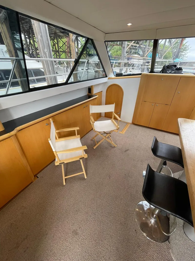 Slide: The Image of Interior of 1997 Roger Hill 11.2m Powercat with chairs and bar stools. - 10