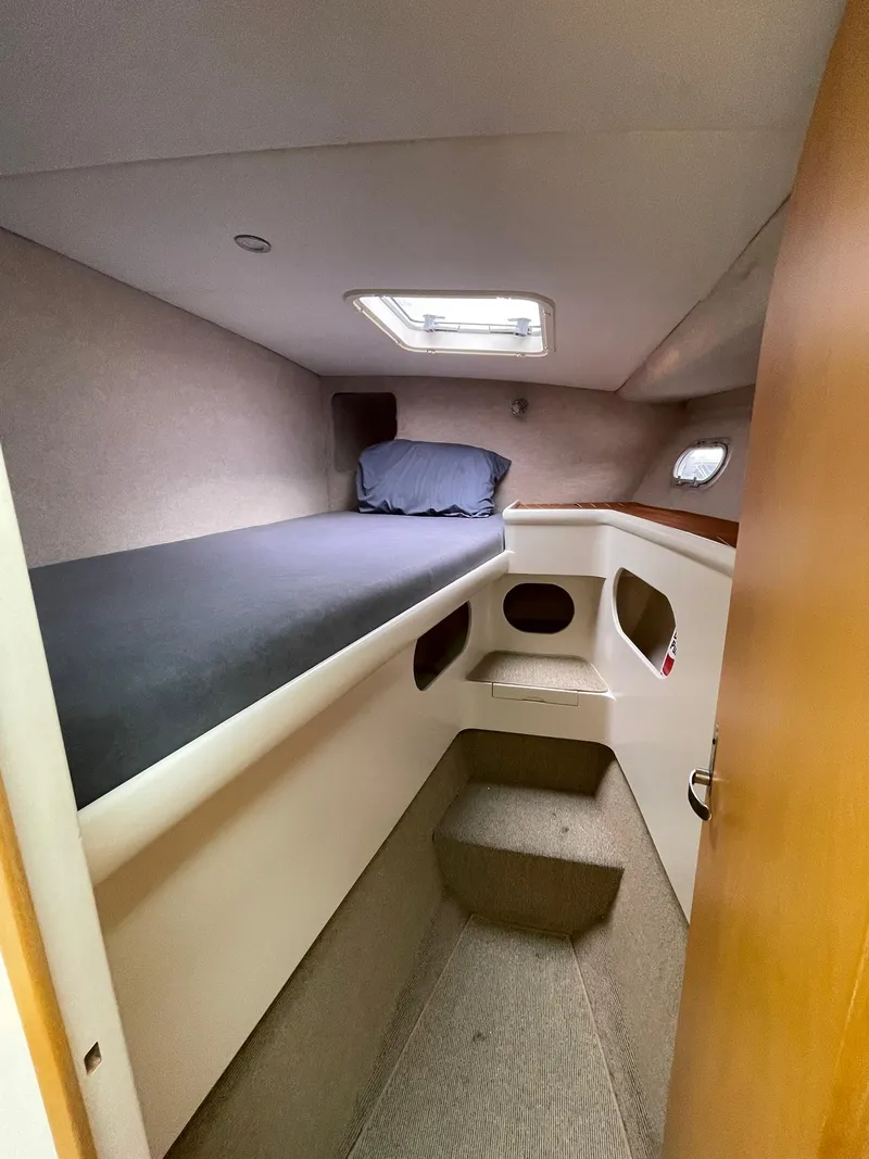 Slide: The Image of Cozy cabin interior of 1997 Roger Hill 11.2m Powercat with bed and porthole. - 13