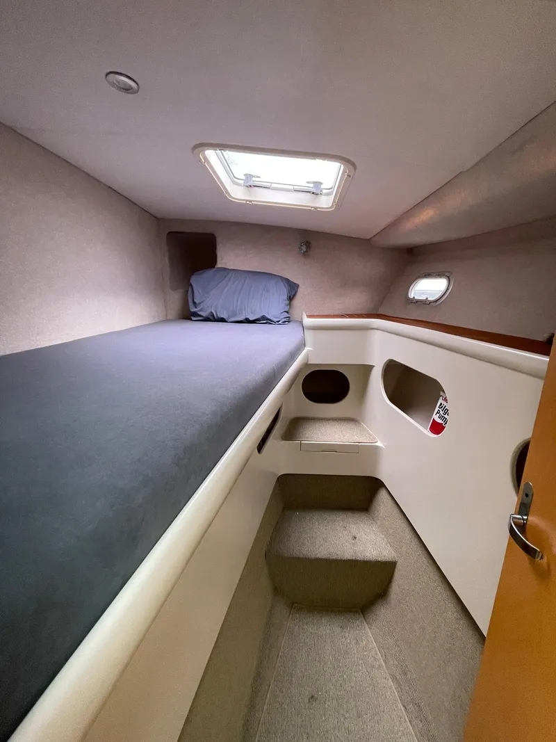 Slide: The Image of Interior cabin of 1997 Roger Hill 11.2m Powercat with bed and porthole. - 14