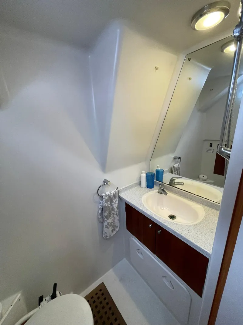Slide: The Image of Bathroom interior of 1997 Roger Hill 11.2m Powercat with sink, mirror, and storage. - 15