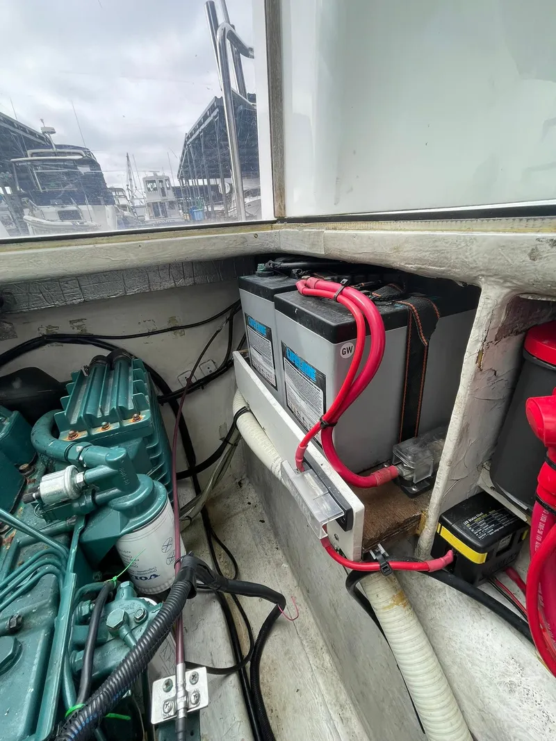 Slide: The Image of Engine compartment of a 1997 Roger Hill 11.2m Powercat with visible batteries and wiring. - 21