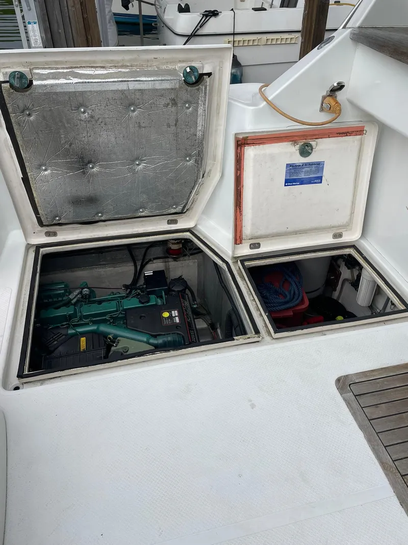 Slide: The Image of Engine compartment of a 1997 Roger Hill 11.2m Powercat, showcasing open hatches and visible machinery. - 25
