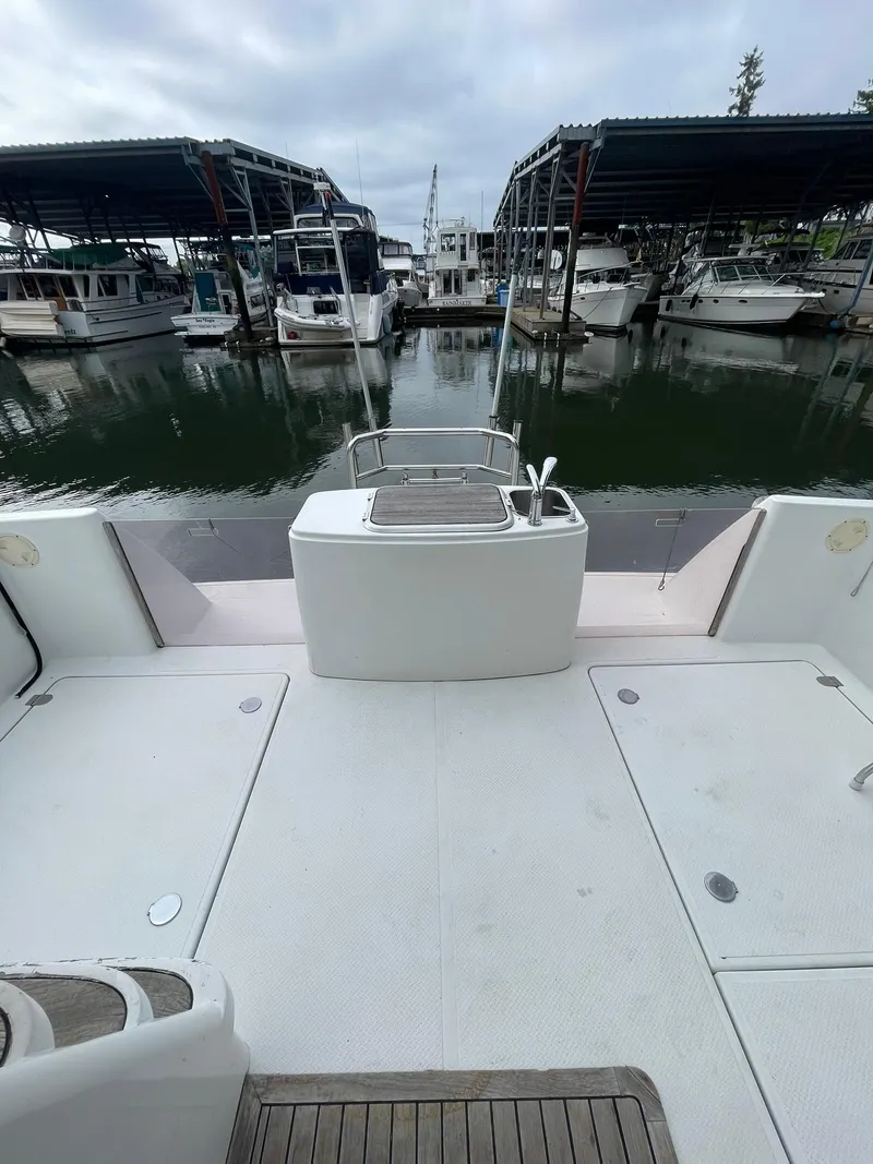 Slide: The Image of 1997 Roger Hill 11.2m Powercat at marina, spacious deck view. - 3