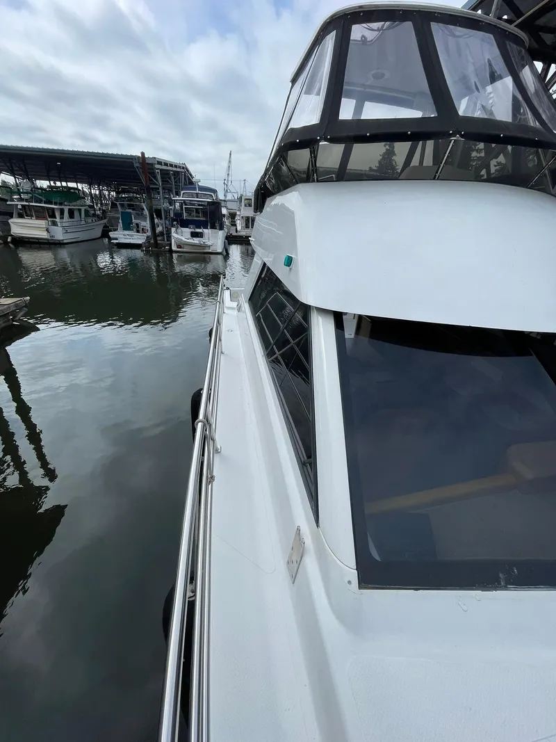 Slide: The Image of Roger Hill 11.2m Powercat, 1997, docked at marina with other boats in background. - 33