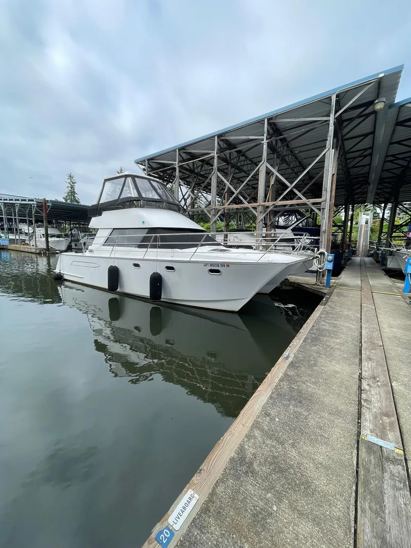 Slide: The Image of 1997 Roger Hill 11.2m Powercat docked at marina under cloudy sky. - 37