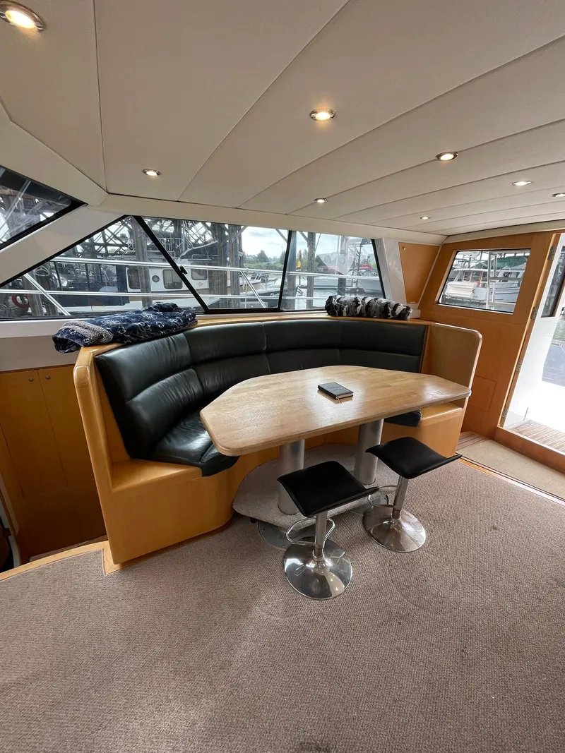 Slide: The Image of Luxurious interior of a 1997 Roger Hill 11.2m Powercat with a cozy dining area. - 4