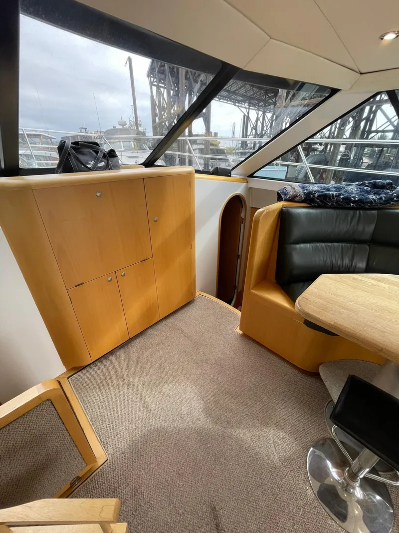 Slide: The Image of Interior of 1997 Roger Hill 11.2m Powercat with seating and wooden cabinetry. - 7