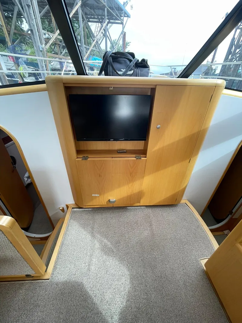 Slide: The Image of Interior of 1997 Roger Hill 11.2m Powercat with wooden cabinetry and mounted TV. - 8