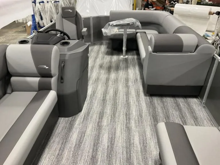 Slide: The Image of 2025 Bennington 20 SL pontoon boat interior with gray seating and striped flooring. - 3