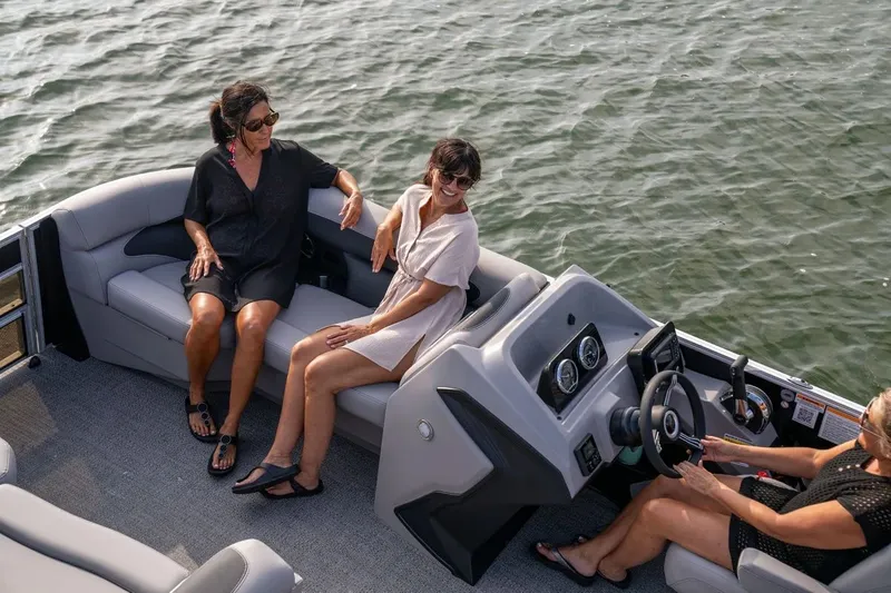 Slide: The Image of Three women relaxing on a 2026 Barletta Aria 22 CC boat. - 2