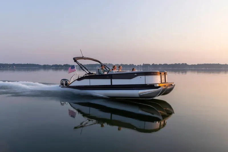 Slide: The Image of Barletta Aria 22 CC 2026 cruising on calm water at sunset. - 4
