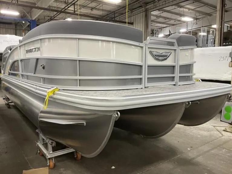 The Image of 2025 Bennington 22 MFB pontoon boat in a warehouse setting. - 1