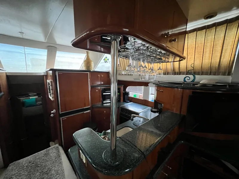 Slide: The Image of Luxurious interior of 2000 Carver 506 Motor Yacht with elegant wood and glass accents. - 15