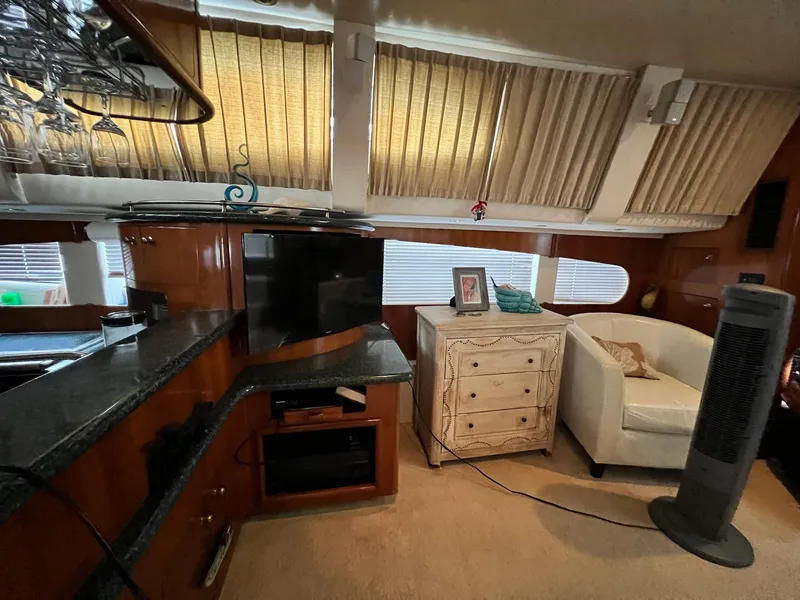 Slide: The Image of Interior of 2000 Carver 506 Motor Yacht with cozy seating and entertainment area. - 17