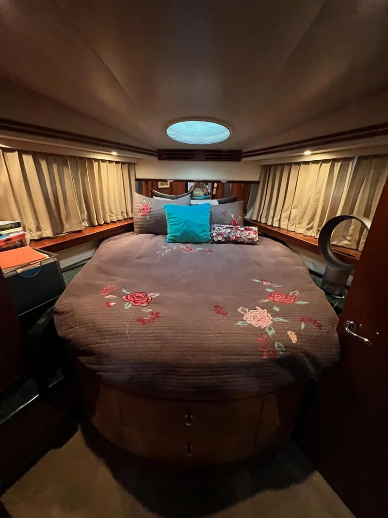 Slide: The Image of Luxurious bedroom in 2000 Carver 506 Motor Yacht with floral bedding and ambient lighting. - 19