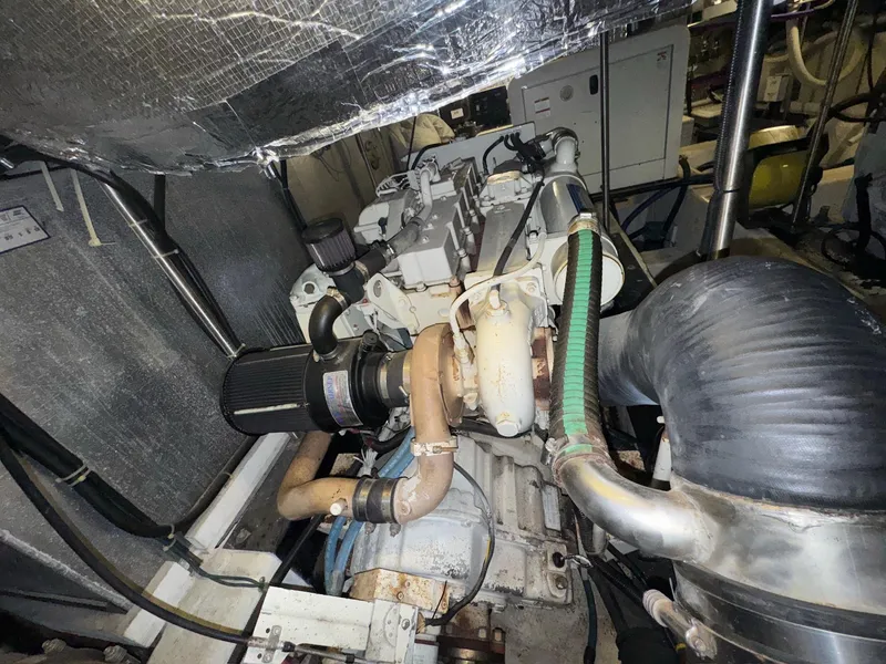 Slide: The Image of Engine room of 2000 Carver 506 Motor Yacht, showcasing mechanical components and piping. - 24