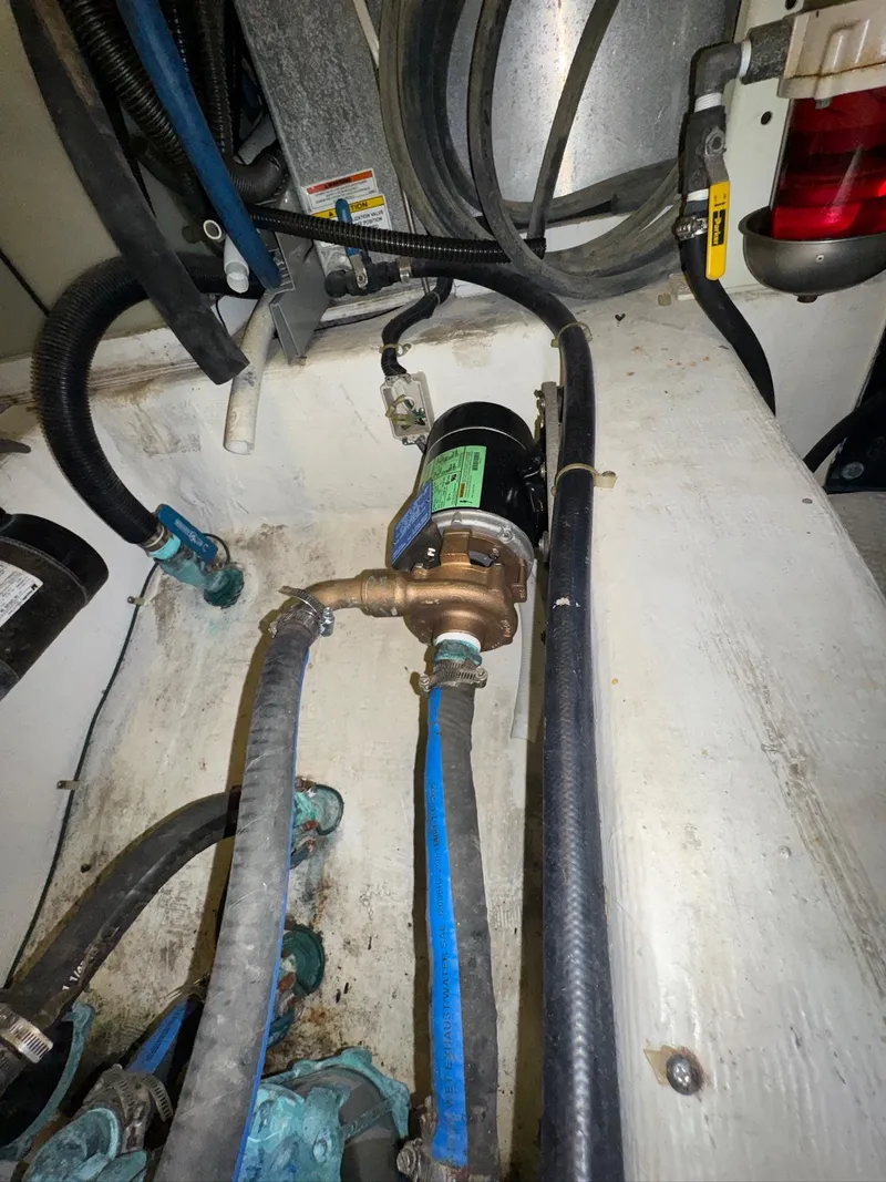 Slide: The Image of Engine room of 2000 Carver 506 Motor Yacht with visible hoses and components. - 26