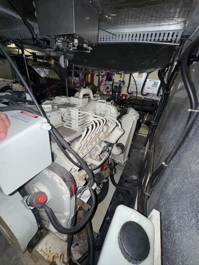 Slide: The Image of Engine room of a 2000 Carver 506 Motor Yacht, showcasing mechanical components and wiring. - 32