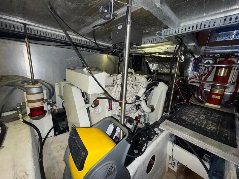 Slide: The Image of Engine room of a 2000 Carver 506 Motor Yacht, featuring mechanical components and wiring. - 34