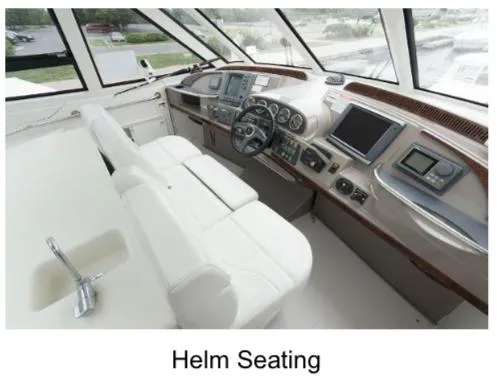 Slide: The Image of Helm seating area of 2000 Carver 506 Motor Yacht with modern controls and navigation displays. - 8