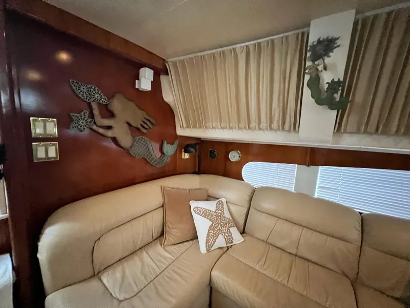 Slide: The Image of Interior of 2000 Carver 506 Motor Yacht with mermaid decor and beige seating. - 18