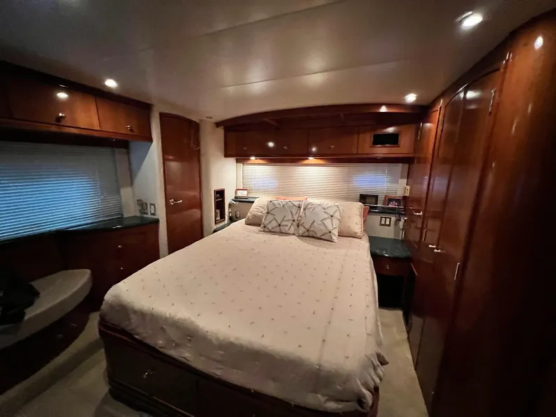 Slide: The Image of Luxurious bedroom interior of 2000 Carver 506 Motor Yacht with wood cabinetry and cozy lighting. - 22