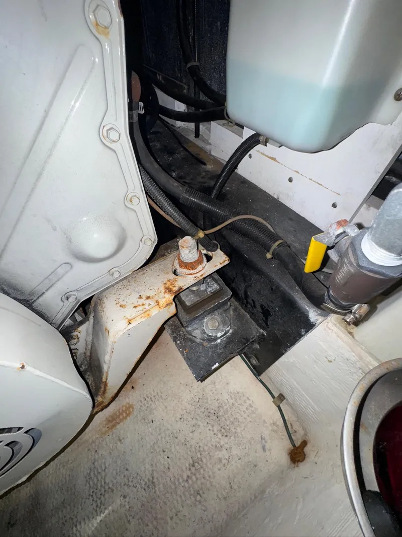 Slide: The Image of Engine compartment of a 2000 Carver 506 Motor Yacht, showing mechanical components and wiring. - 33