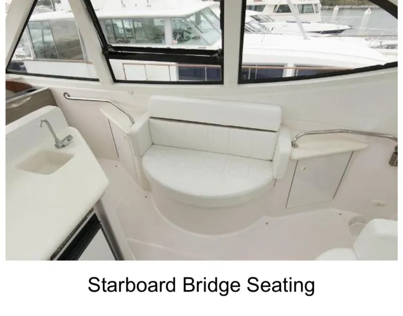 Slide: The Image of Starboard bridge seating on 2000 Carver 506 Motor Yacht, featuring white cushioned bench. - 5
