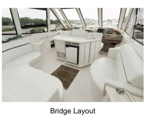 Slide: The Image of Bridge layout of 2000 Carver 506 Motor Yacht with white seating and helm. - 9