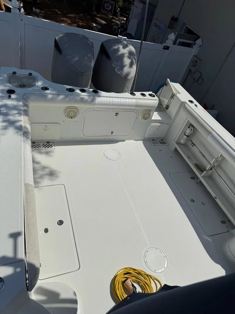 Slide: The Image of 2008 Sailfish 30-06 Express boat deck with dual engines and coiled rope. - 12