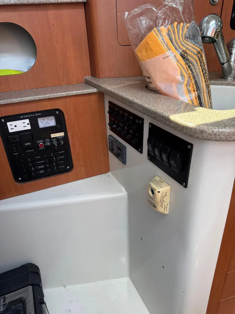 Slide: The Image of Control panel and sink area on a 2008 Sailfish 30-06 Express boat. - 13