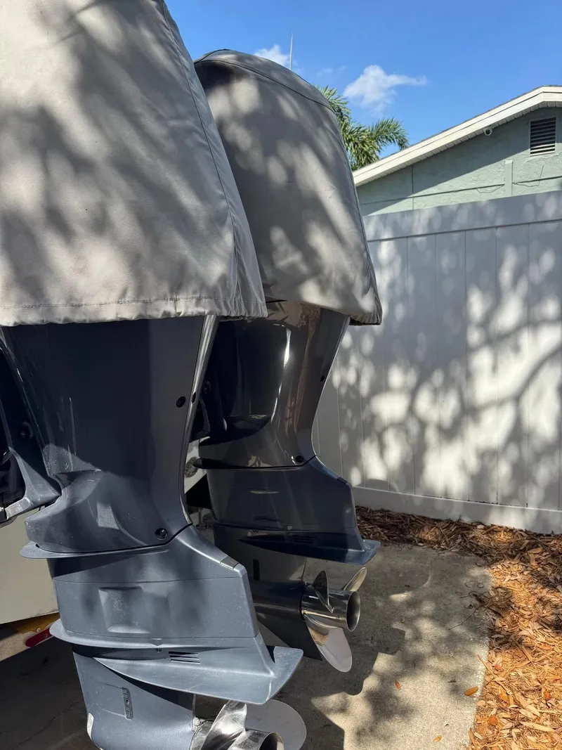 Slide: The Image of Twin outboard motors on a 2008 Sailfish 30-06 Express boat, covered and parked outdoors. - 14