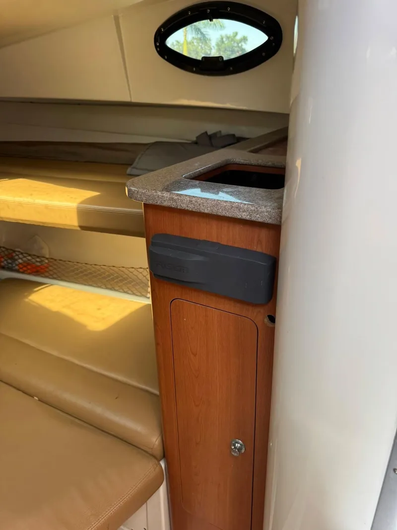 Slide: The Image of Interior of 2008 Sailfish 30-06 Express boat with wood cabinetry and seating. - 2
