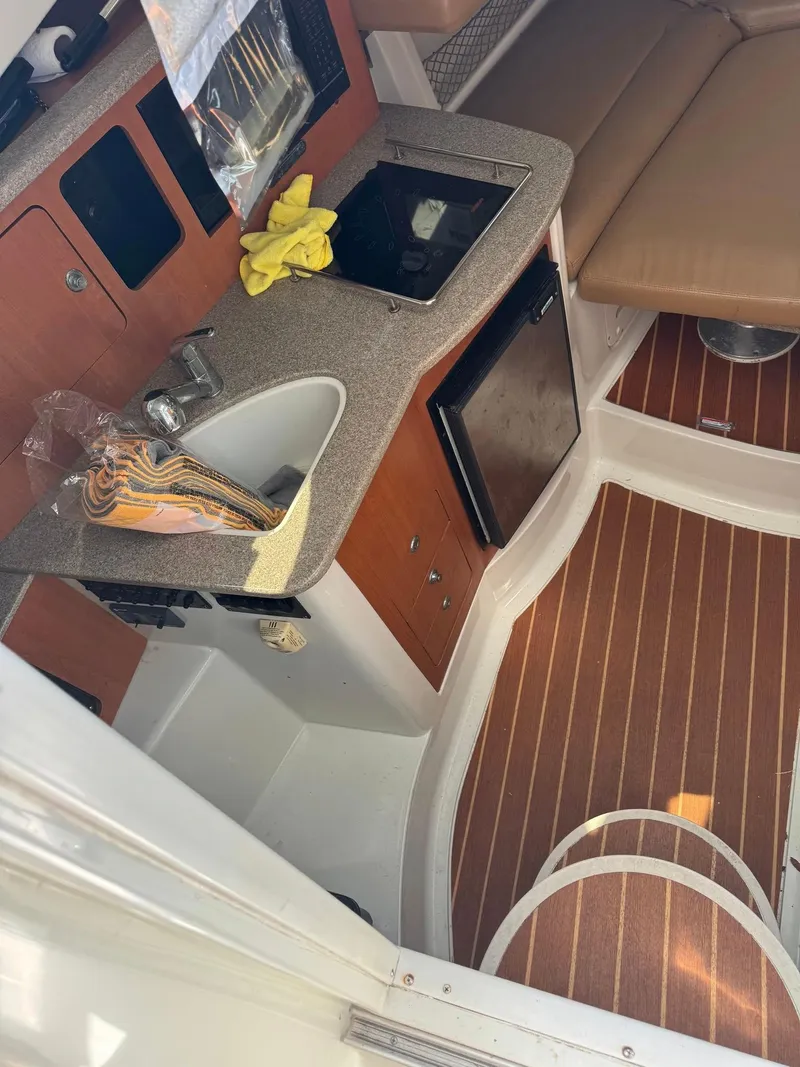 Slide: The Image of 2008 Sailfish 30-06 Express cabin interior with kitchenette and seating area. - 4