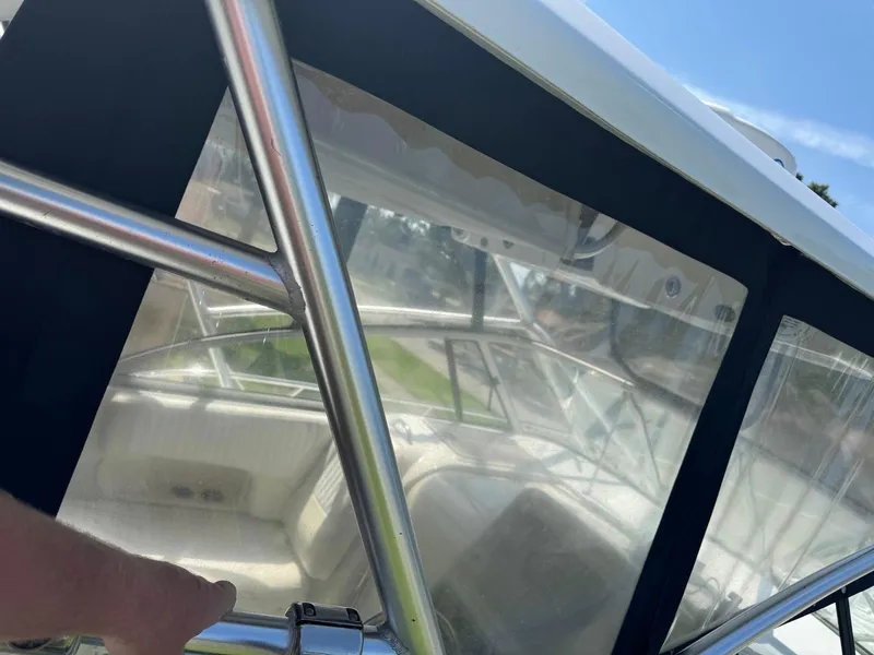 Slide: The Image of 2008 Sailfish 30-06 Express boat interior with clear enclosure and metal frame. - 6